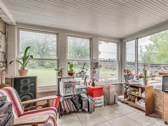 sunroom featuring tile patterned floors and a healthy amount of sunlight