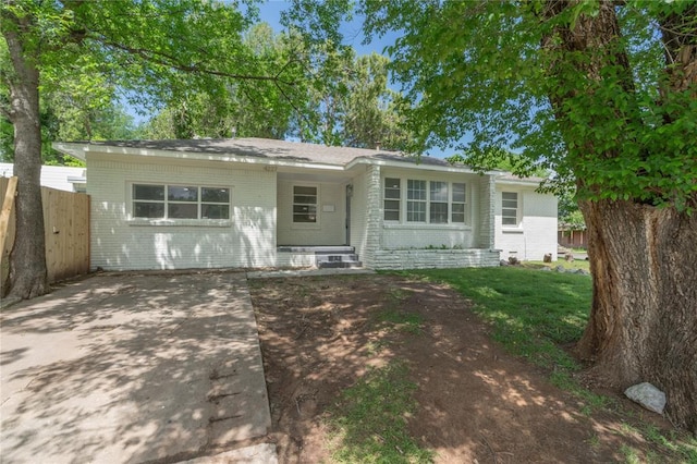 view of front of home with fence and brick siding