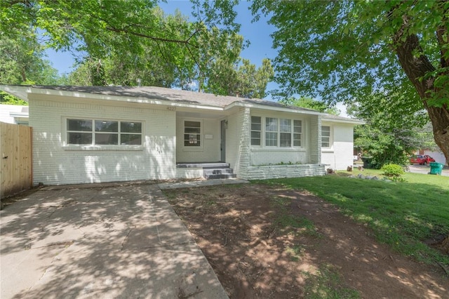 single story home with fence and brick siding