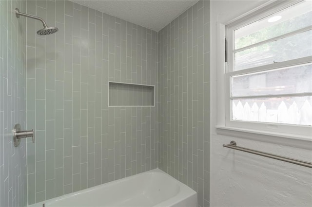 full bathroom featuring shower / bathtub combination, plenty of natural light, and a textured ceiling