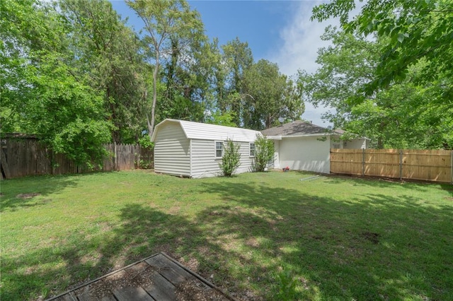 view of yard with a fenced backyard and an outdoor structure