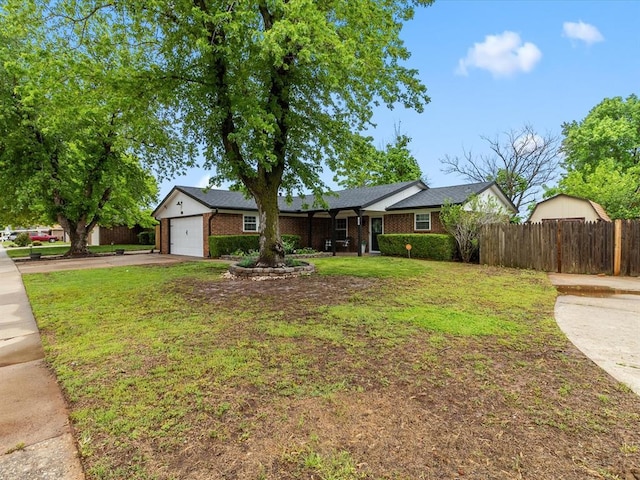 ranch-style house with fence, a garage, a front lawn, and aphalt driveway