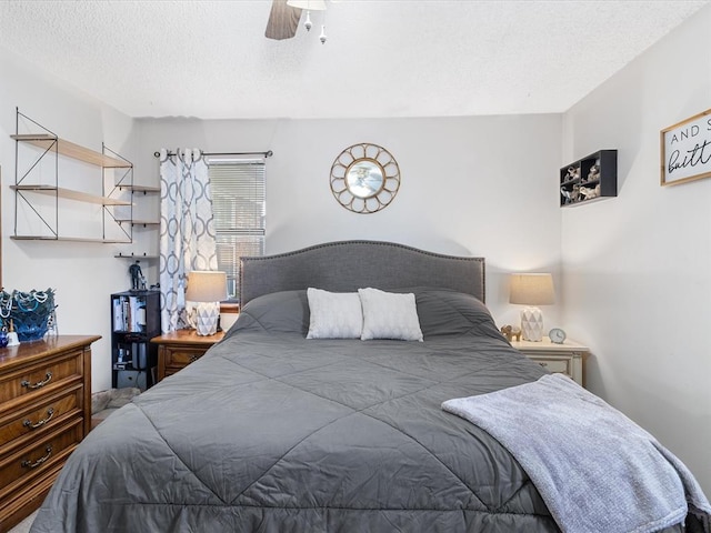 bedroom featuring a textured ceiling and ceiling fan