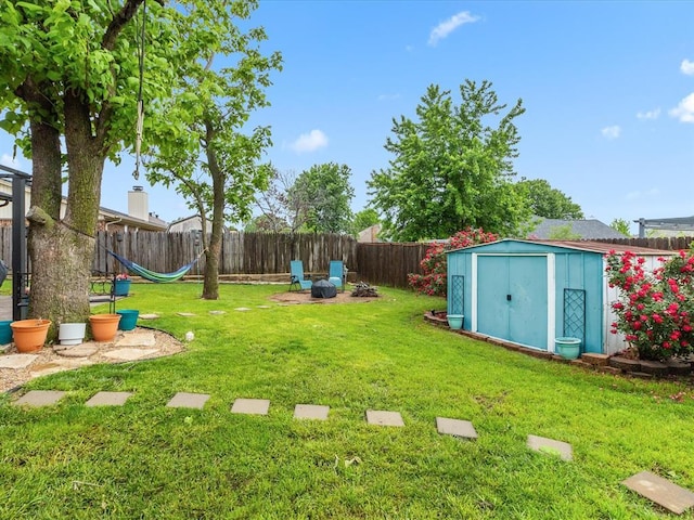 view of yard with a playground, an outbuilding, a shed, and a fenced backyard