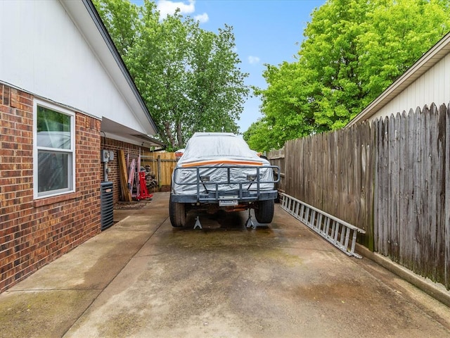 view of vehicle parking with fence