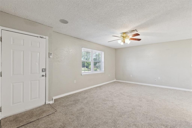 586 Seikel Dr, Choctaw, OK 73020 - spare room featuring a ceiling fan, carpet flooring, baseboards, and a textured ceiling