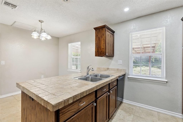 586 Seikel Dr, Choctaw, OK 73020 - kitchen featuring a sink, a textured ceiling, a chandelier, a peninsula, and plenty of natural light