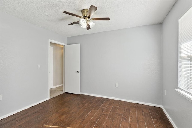 586 Seikel Dr, Choctaw, OK 73020 - spare room with wood finished floors, ceiling fan, baseboards, and a textured ceiling