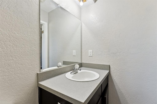 586 Seikel Dr, Choctaw, OK 73020 - bathroom featuring a textured wall and vanity