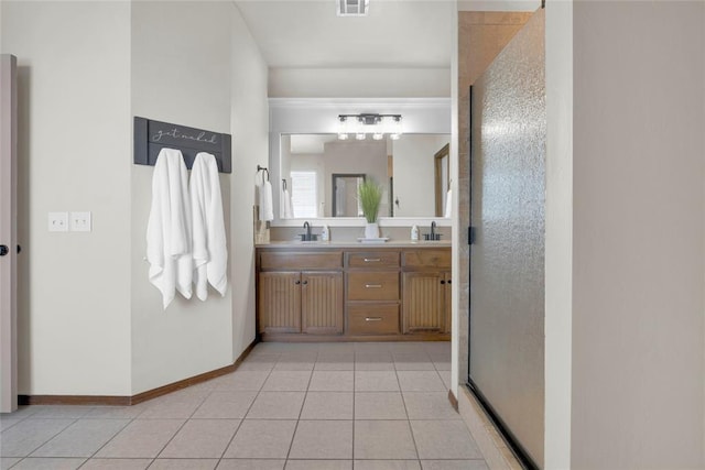 4679 Hillcrest Ln, Edmond, OK 73025 - full bathroom with double vanity, tile patterned flooring, a shower with shower door, a sink, and baseboards