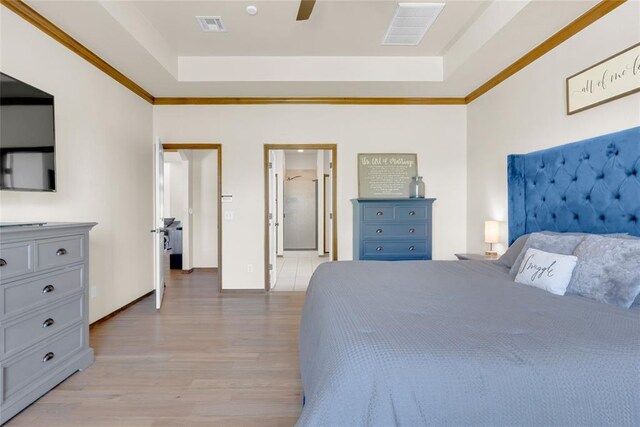 4679 Hillcrest Ln, Edmond, OK 73025 - bedroom with a raised ceiling, light wood-type flooring, and crown molding