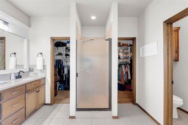 4679 Hillcrest Ln, Edmond, OK 73025 - full bathroom with a walk in closet, vanity, and a shower stall