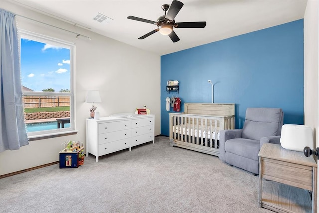 4679 Hillcrest Ln, Edmond, OK 73025 - carpeted bedroom with a crib and a ceiling fan