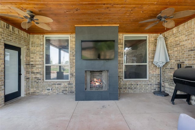 4679 Hillcrest Ln, Edmond, OK 73025 - view of patio / terrace with a fireplace, a ceiling fan, and area for grilling