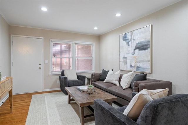 living area with crown molding, recessed lighting, baseboards, and light wood-type flooring