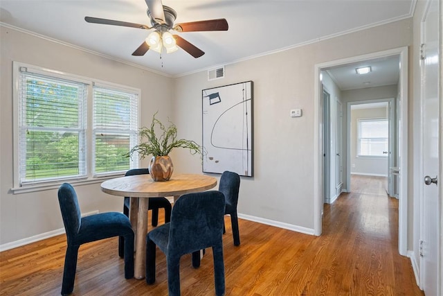 dining area with baseboards, plenty of natural light, light wood-style flooring, and visible vents