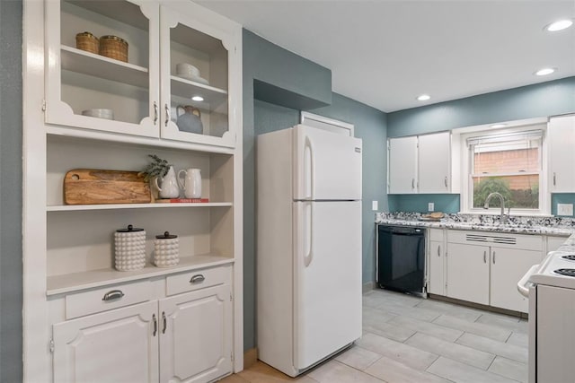 kitchen featuring freestanding refrigerator, dishwasher, white cabinets, a sink, and range
