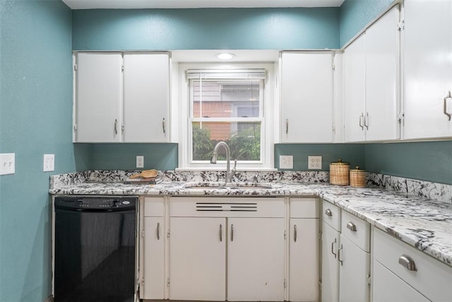 kitchen with a sink, white cabinets, light stone countertops, and dishwasher
