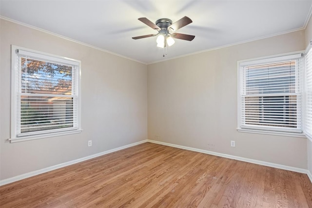 empty room featuring crown molding, baseboards, ceiling fan, and light wood finished floors