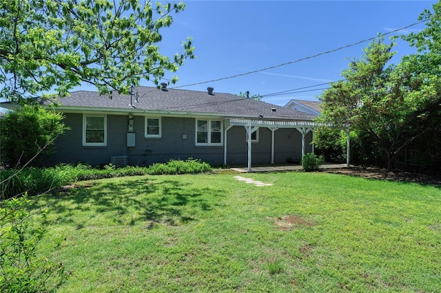 rear view of house featuring a lawn, a pergola, a patio, and central air condition unit