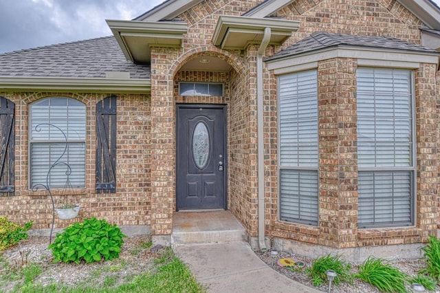 908 County St Unit 2932, Tuttle, OK 73089 - view of exterior entry featuring brick siding and roof with shingles
