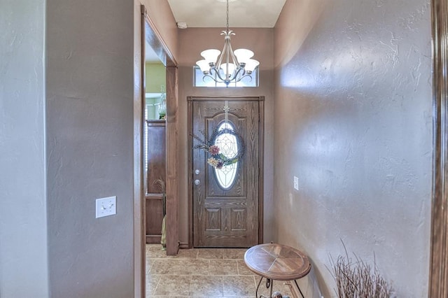 908 County St Unit 2932, Tuttle, OK 73089 - tiled entryway featuring a textured wall and a notable chandelier