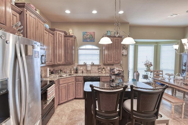 908 County St Unit 2932, Tuttle, OK 73089 - kitchen with appliances with stainless steel finishes, light stone counters, a sink, recessed lighting, and backsplash