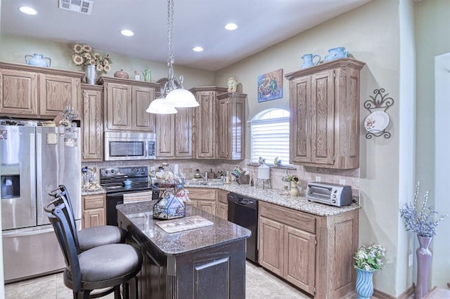 908 County St Unit 2932, Tuttle, OK 73089 - kitchen featuring visible vents, a center island, tasteful backsplash, light stone counters, and black appliances