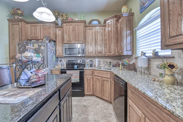 908 County St Unit 2932, Tuttle, OK 73089 - kitchen featuring a sink, light stone counters, tasteful backsplash, and black appliances