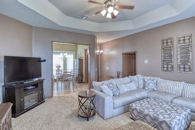 908 County St Unit 2932, Tuttle, OK 73089 - carpeted living room with visible vents, a raised ceiling, and ceiling fan with notable chandelier