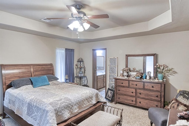 908 County St Unit 2932, Tuttle, OK 73089 - bedroom featuring a ceiling fan, visible vents, ensuite bathroom, light carpet, and a tray ceiling
