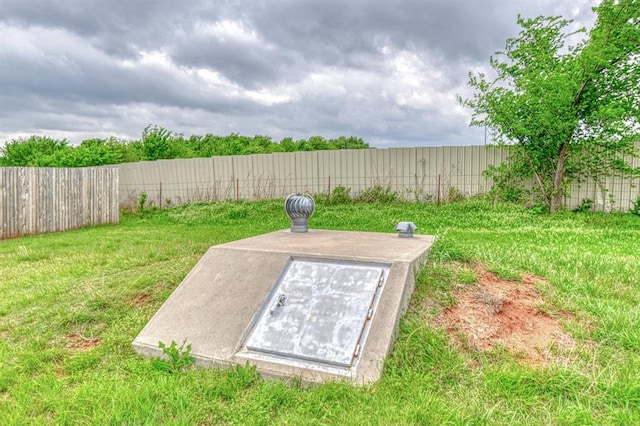 908 County St Unit 2932, Tuttle, OK 73089 - entry to storm shelter with a lawn and a fenced backyard