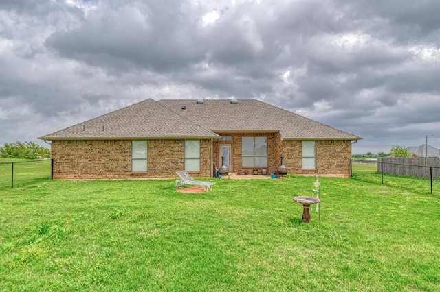908 County St Unit 2932, Tuttle, OK 73089 - rear view of house with a lawn, a fenced backyard, and brick siding