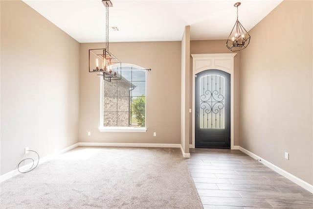 7217 SW 120th St, Oklahoma City, OK 73173 - foyer entrance featuring wood finished floors, a chandelier, and baseboards