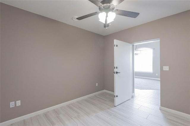 7217 SW 120th St, Oklahoma City, OK 73173 - empty room featuring a ceiling fan, light wood-style flooring, and baseboards