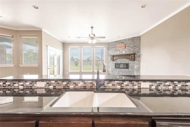7217 SW 120th St, Oklahoma City, OK 73173 - kitchen featuring a ceiling fan, backsplash, crown molding, and a sink