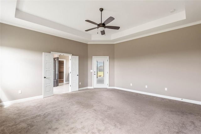 7217 SW 120th St, Oklahoma City, OK 73173 - spare room with carpet flooring, ceiling fan, a tray ceiling, baseboards, and ornamental molding