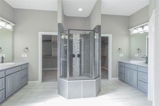 7217 SW 120th St, Oklahoma City, OK 73173 - bathroom featuring two vanities, a spacious closet, a shower stall, and a sink