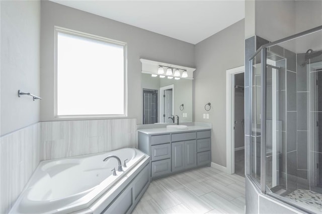 7217 SW 120th St, Oklahoma City, OK 73173 - bathroom featuring a tub with jets, a shower stall, and vanity