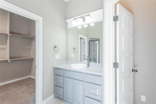 7217 SW 120th St, Oklahoma City, OK 73173 - bathroom featuring baseboards, vanity, and a spacious closet
