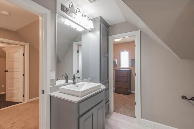 7217 SW 120th St, Oklahoma City, OK 73173 - bathroom featuring lofted ceiling, vanity, and baseboards