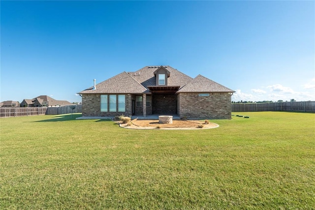 7217 SW 120th St, Oklahoma City, OK 73173 - back of house featuring a yard, a shingled roof, a fenced backyard, and brick siding