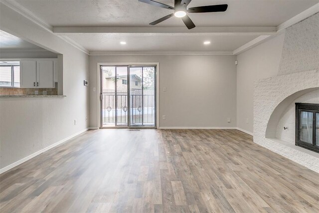 7705 Rumsey Rd, Oklahoma City, OK 73132 - unfurnished living room with crown molding, ceiling fan, beam ceiling, and light wood-type flooring