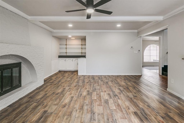 7705 Rumsey Rd, Oklahoma City, OK 73132 - unfurnished living room featuring wood finished floors, beamed ceiling, baseboards, a ceiling fan, and crown molding