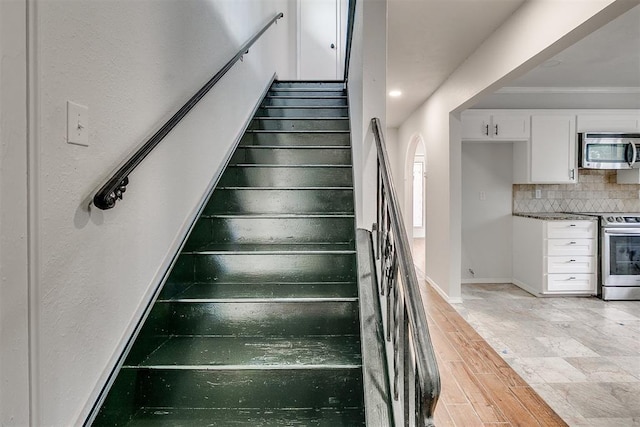 7705 Rumsey Rd, Oklahoma City, OK 73132 - staircase featuring baseboards, ornamental molding, and wood finished floors