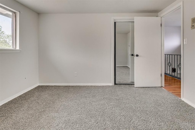 7705 Rumsey Rd, Oklahoma City, OK 73132 - unfurnished bedroom featuring carpet, a closet, and baseboards