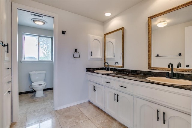7705 Rumsey Rd, Oklahoma City, OK 73132 - bathroom featuring double vanity, visible vents, toilet, and a sink