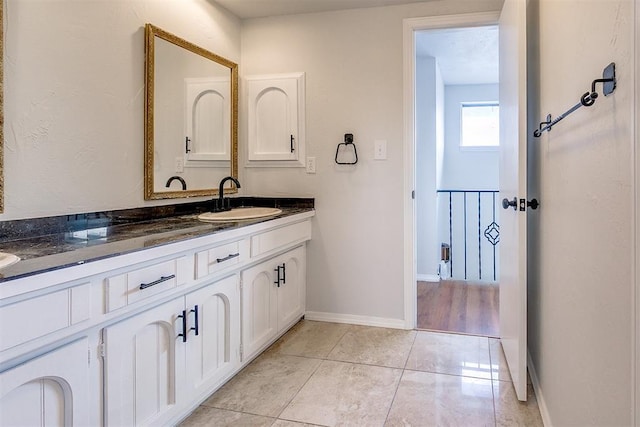 7705 Rumsey Rd, Oklahoma City, OK 73132 - bathroom with double vanity, a sink, tile patterned floors, and baseboards