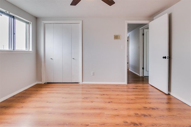 7705 Rumsey Rd, Oklahoma City, OK 73132 - unfurnished bedroom with a closet, a ceiling fan, light wood finished floors, and baseboards