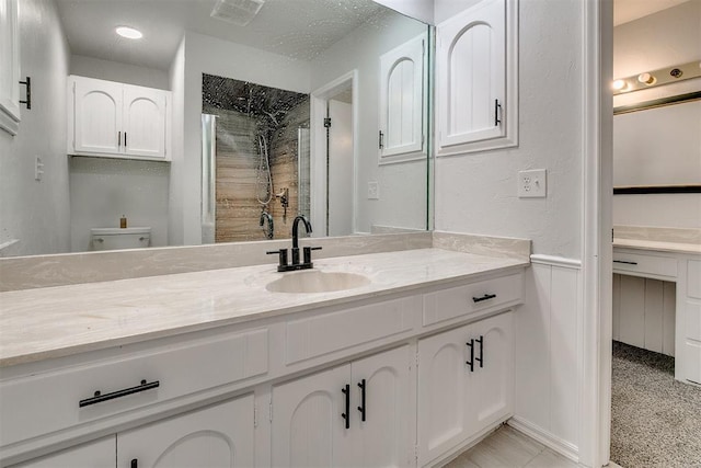 7705 Rumsey Rd, Oklahoma City, OK 73132 - bathroom with toilet, visible vents, a shower stall, and vanity